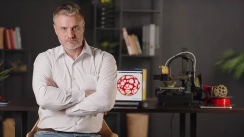 A positive smiling middle aged man graphic designer uses a laptop and creates Stock Footage 260068042