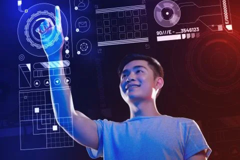 Positive software developer touching the hologram and feeling interested 스톡 사진