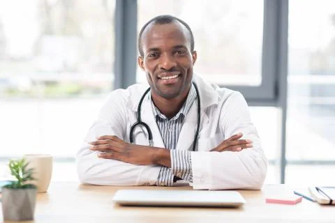 Positive student keeping arm on the table Stock Photos
