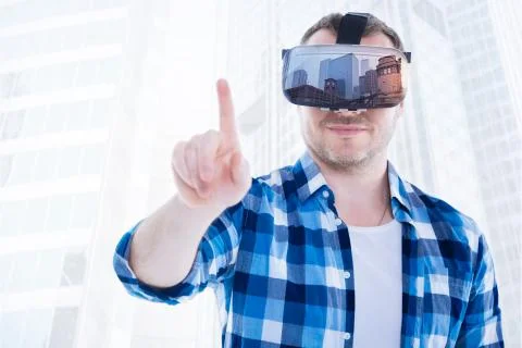 Positive student looking through virtual reality glasses Stock Photos