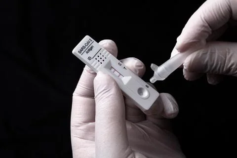 Positive test result by using rapid test device for COVID-19. Stock Photos