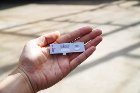 Positive test result by using rapid test device for COVID-19 virus, novel c.. Stock Photos