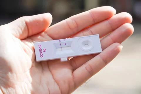 Positive test result by using rapid test device for COVID-19 virus, novel c.. Stock Photos