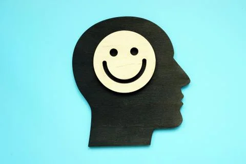 Positive thinking concept. Head shape and smiley face on it. Stock Photos