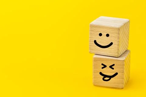 Positive thinking, creative concept, hand painted facial expression on wood.. Stock Photos