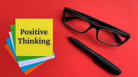 Positive thinking text on yellow notepad with red cover and glasses background Stock Photos