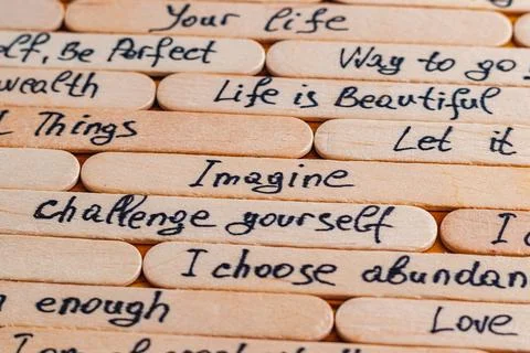 Positive thoughts for increasing selfesteem on wooden posts on wooden backg.. Stock Photos