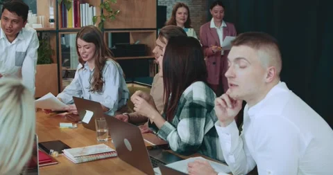 Positive workplace atmosphere. Happy creative coworkers cooperate, discuss work Stock Footage 186691855