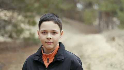 Positive young boy dacning in a forest 库存影片 104708038