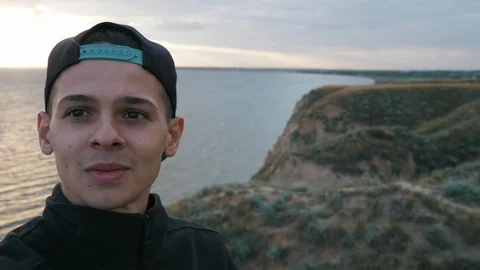 Positive young boy doing video selfie (shooting yourself) on the mountain near Stock Footage 111874351