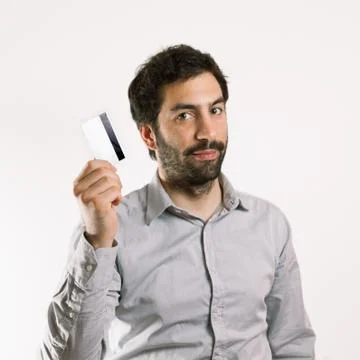 Positive young man holding a credit card Stock Photos