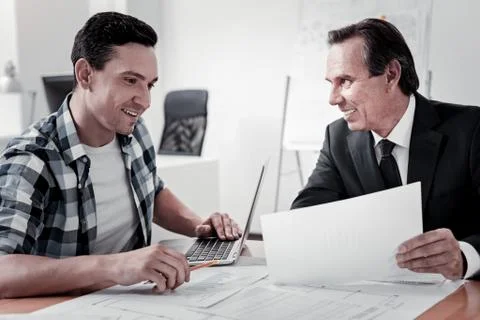 Positive young man looking at document Foto stock