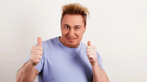 Positive young man showing thumb up, winner gesture. Excited guy Stock Footage 234531867