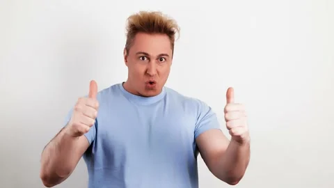 Positive young man showing thumb up, winner gesture. Excited guy Stock Footage 235366640