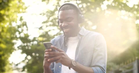 Positive Young Man Student Texting Happy Message while standing on the Street Stock Footage 151028816