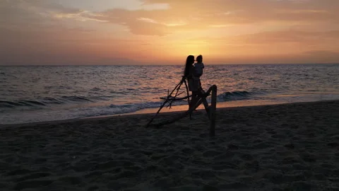 Possidi Beach Sunset Parent Holding Child Left-to-Right Drone Shot, Greece 스톡 동영상 329773806
