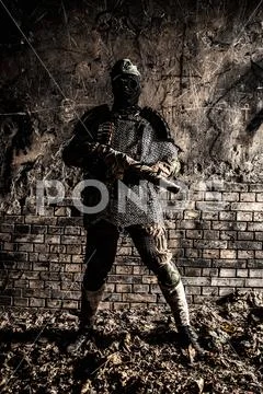 Post apocalypse soldier aiming with handmade gun Stock Photos