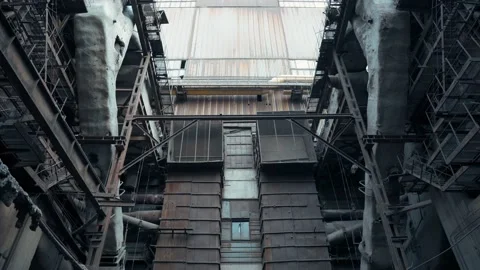 Post-apocalyptic view of an abandoned factory with huge rusty metal pipes Stock Footage 229247162