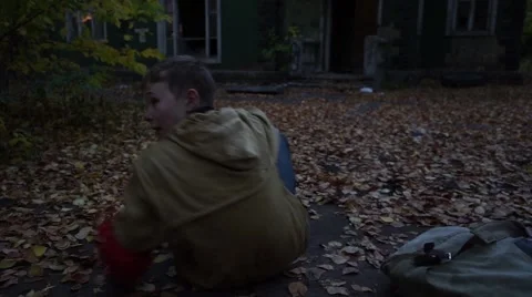 Post-apocalyptic world. The wanderer a young man with a backpack sitting on the Stock Footage 68205662