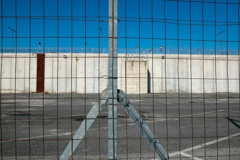Post border with wire mesh. Galvanized posts, anonymous fence. borders with Stock Photos