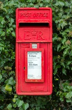 Post box, red Royal Mail postbox on wall, UK Stock Photos