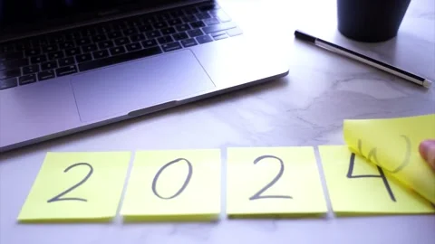 Post it changing from 2023 to 2024 for new year on a desk Stock Footage 257064508