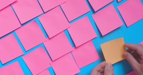 Post it notes on blue wall 스톡 동영상 107669825