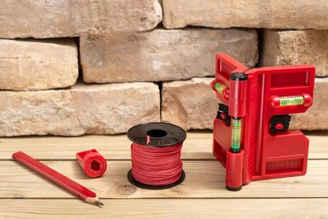 Post levelers set and bricks on wooden background Stock Photos