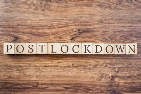 Post-lockdown text and a hand adding the block Stock Photos