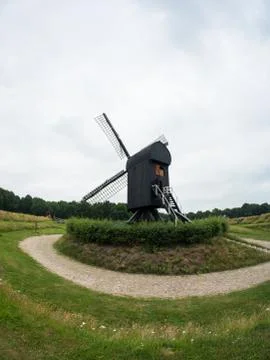 Post mill type windmill in Dutch landscape Stock Photos