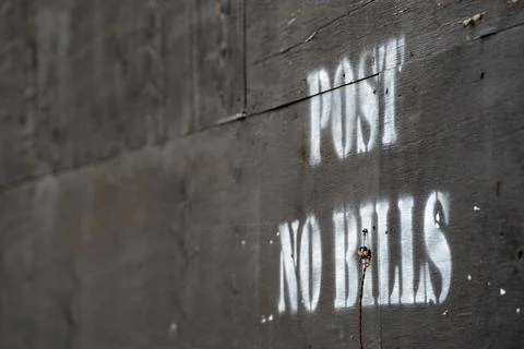 Post no bills stencil graffiti text on wooden wall surface Stock Photos