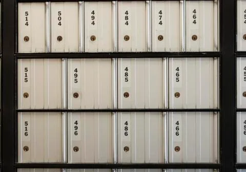 Post office boxes are numbered with three digits and they are all closed Stock Photos
