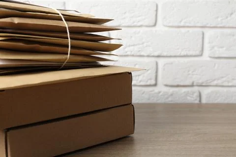Post office. Different paper envelopes and parcels on wooden table, closeup.. Stock Photos