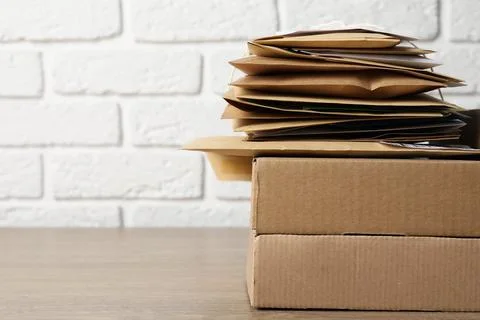 Post office. Different paper envelopes and parcels on wooden table, closeup.. 스톡 사진