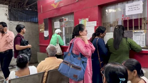 Post office in India with people queueing at the service counter Stock Footage 337161193