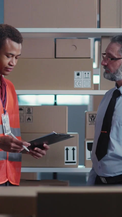 Post Office. Multi-Race Couple of Male Workers Discussing Delivery Information Stock Footage 313788455