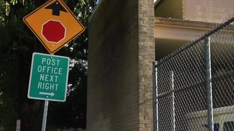 Post Office Next Right sign below a Stop Ahead road sign in Gresham, Stock Footage 138835310