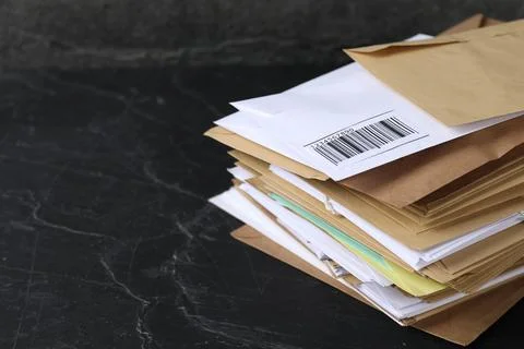 Post office. Stack of different paper envelopes on black table, closeup. Sp.. 스톡 사진
