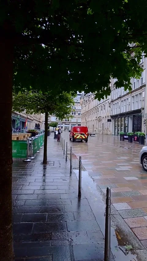 A post office van passing in the rain - Vertical Video Stock Footage 200400613