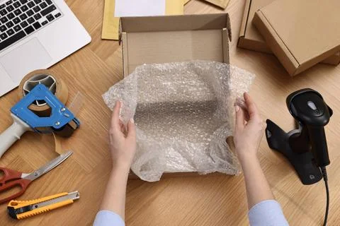 Post office worker packing parcel at wooden table, top view Stock Photos