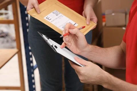 Post office workers checking parcel barcode indoors, closeup Stockfoto's