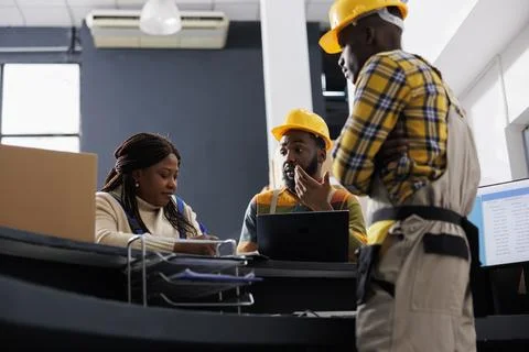 Post office workers managing parcel receiving at counter desk Stock Photos