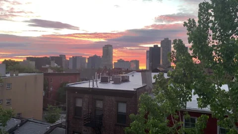 Post-Storm Pink Sunset over the rooftops of Jersey City, New Jersey Video stock 133461309