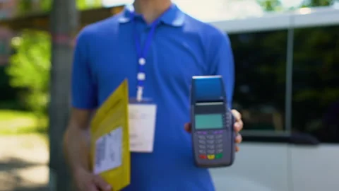Post worker showing parcel and credit card terminal, payment service client care Stock Footage 91243270