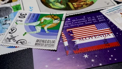 Postage stamps of different shapes and sizes, placed on rotating display table Stock Footage 263044878