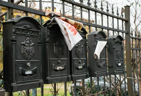 Postal chases over the iron wall on the street Stock Photos