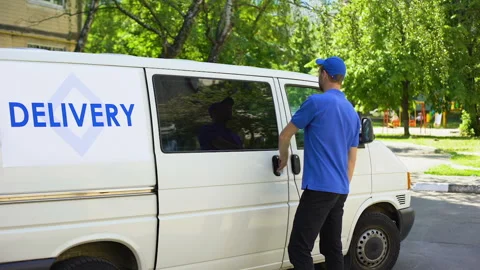 Postal office worker taking parcel box from delivery van and showing thumbs up Stock Footage 91243563