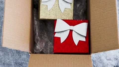Postal parcel with Christmas themed items inside of it including sparkly pres 스톡 동영상 143223390