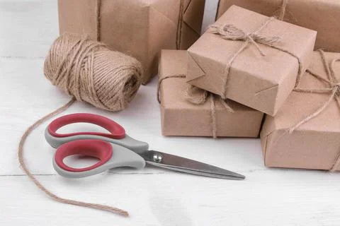 Postal parcels. boxes wrapped in craft paper on a white wooden table. mail or 스톡 사진