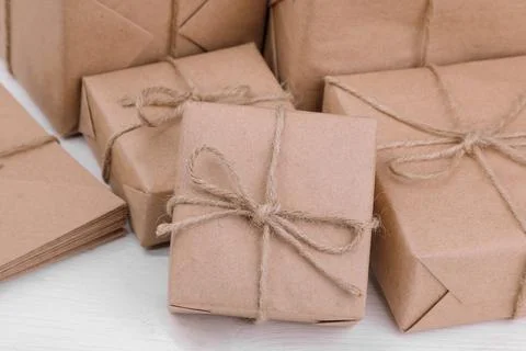 Postal parcels. boxes wrapped in craft paper on a white wooden table. mail or 스톡 사진